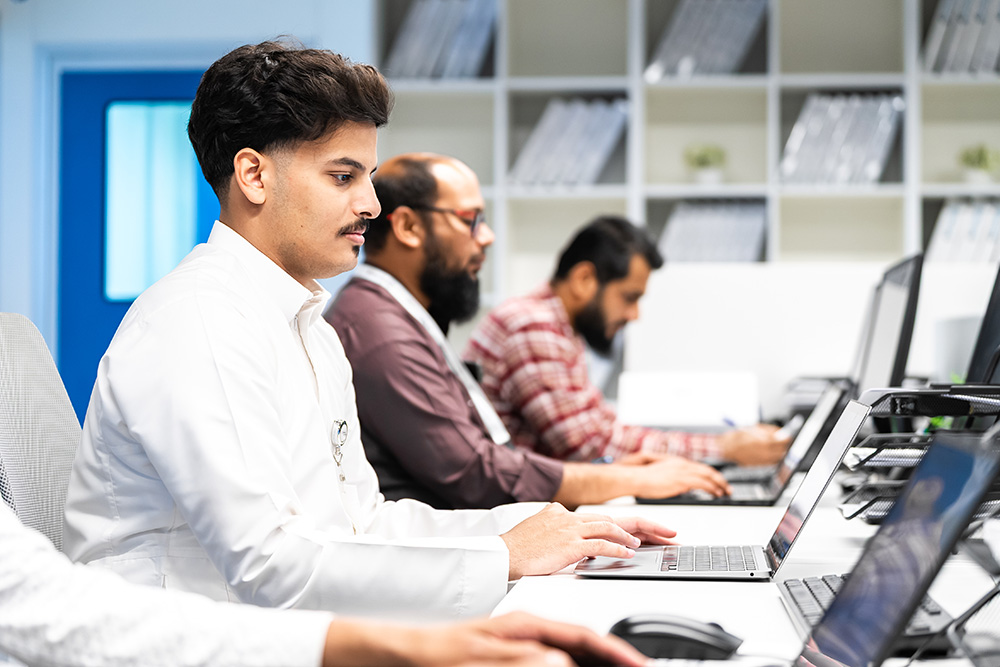 Boston Oncology Arabia office with team members on laptops